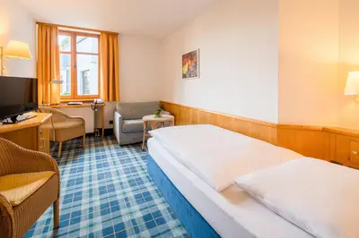 Ein Bett oder Betten in einem Zimmer der Unterkunft Hotel Am Nockherberg