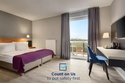 Ein Bett oder Betten in einem Zimmer der Unterkunft Ramada by Wyndham München Airport