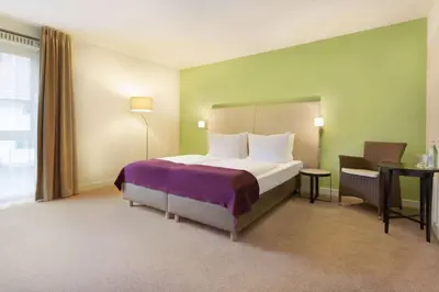 Ein Bett oder Betten in einem Zimmer der Unterkunft Ramada by Wyndham München Airport