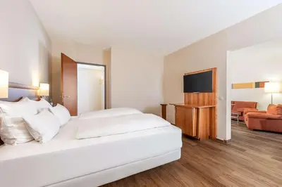 Ein Bett oder Betten in einem Zimmer der Unterkunft NH München Ost Conference Center