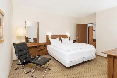 Ein Bett oder Betten in einem Zimmer der Unterkunft NH München Ost Conference Center