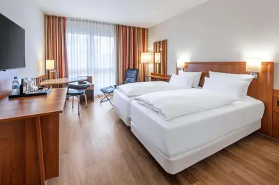 Ein Bett oder Betten in einem Zimmer der Unterkunft NH München Ost Conference Center