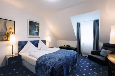 Ein Bett oder Betten in einem Zimmer der Unterkunft Hotel Nymphenburg City - München