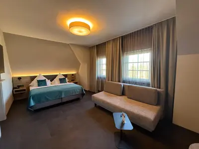 Ein Bett oder Betten in einem Zimmer der Unterkunft Schlosshotel Grünwald