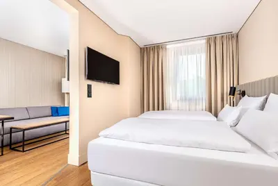 Ein Bett oder Betten in einem Zimmer der Unterkunft NH München Unterhaching