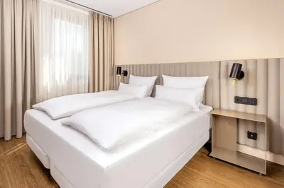 Ein Bett oder Betten in einem Zimmer der Unterkunft NH München Unterhaching