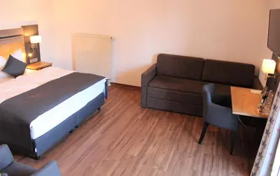Ein Bett oder Betten in einem Zimmer der Unterkunft Zum Goldenen Schwanen