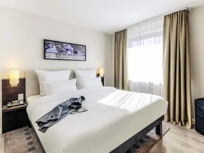 Ein Bett oder Betten in einem Zimmer der Unterkunft Mercure Hotel München Süd Messe