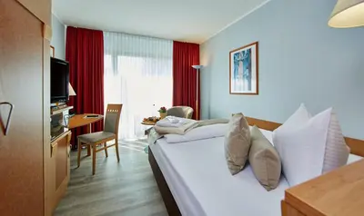 Ein Bett oder Betten in einem Zimmer der Unterkunft Hotel Königshof