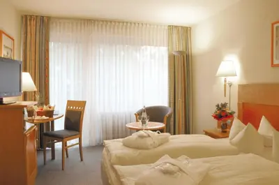 Ein Bett oder Betten in einem Zimmer der Unterkunft Hotel Königshof