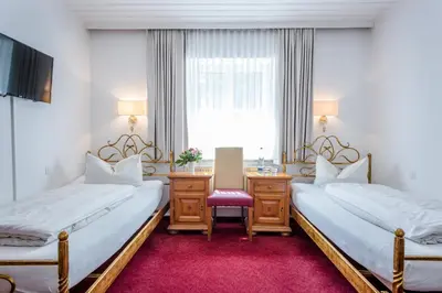 Ein Bett oder Betten in einem Zimmer der Unterkunft Laimer Hof am Schloss Nymphenburg