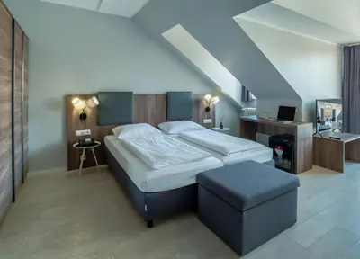 Ein Bett oder Betten in einem Zimmer der Unterkunft Hotel Astor