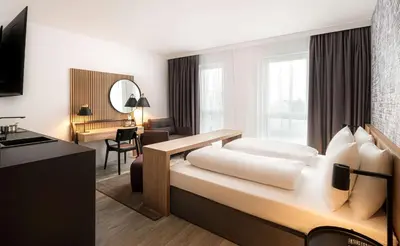 Ein Bett oder Betten in einem Zimmer der Unterkunft elaya hotel augsburg, Trademark by Wyndham