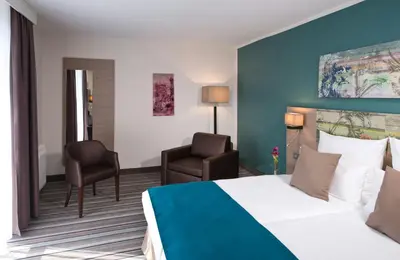Ein Bett oder Betten in einem Zimmer der Unterkunft Leonardo Hotel Munich City Olympiapark
