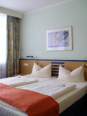 Ein Bett oder Betten in einem Zimmer der Unterkunft Superior Hotel Präsident