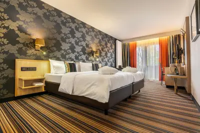 Ein Bett oder Betten in einem Zimmer der Unterkunft DER HEIDEHOF Conference & SPA Resort