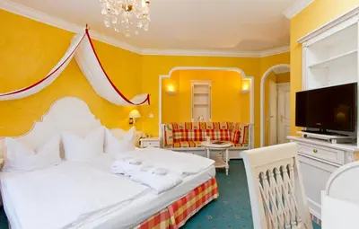 Ein Bett oder Betten in einem Zimmer der Unterkunft Wittelsbacher Hof Swiss Quality Hotel