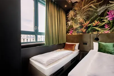 Ein Bett oder Betten in einem Zimmer der Unterkunft Rugs Hotel Augsburg, Trademark Collection by Wyndham