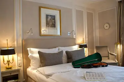 Ein Bett oder Betten in einem Zimmer der Unterkunft Hotel München Palace