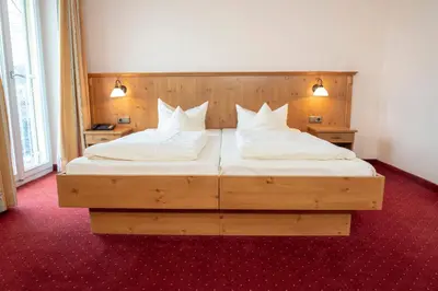 Ein Bett oder Betten in einem Zimmer der Unterkunft Hotel Luitpold am See