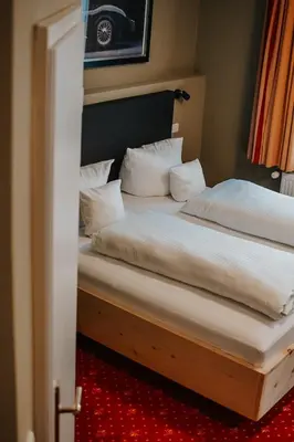 Ein Bett oder Betten in einem Zimmer der Unterkunft Hotel Fletzinger