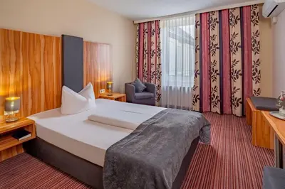 Ein Bett oder Betten in einem Zimmer der Unterkunft Arthotel ANA Style Augsburg