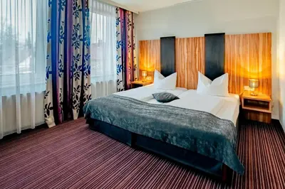 Ein Bett oder Betten in einem Zimmer der Unterkunft Arthotel ANA Style Augsburg