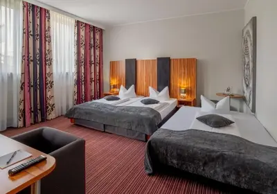 Ein Bett oder Betten in einem Zimmer der Unterkunft Arthotel ANA Style Augsburg
