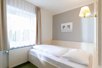 Ein Bett oder Betten in einem Zimmer der Unterkunft Landhotel Restaurant Huberhof Allershausen