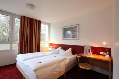 Ein Bett oder Betten in einem Zimmer der Unterkunft Andante Hotel Erding