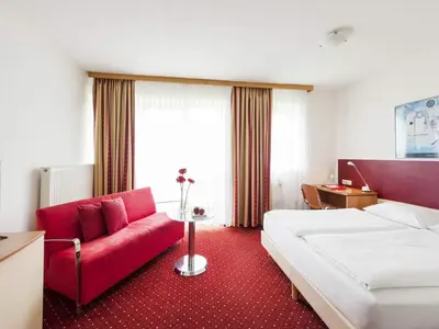 Ein Bett oder Betten in einem Zimmer der Unterkunft Andante Hotel Erding