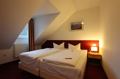 Ein Bett oder Betten in einem Zimmer der Unterkunft Andante Hotel Erding