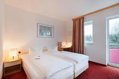 Ein Bett oder Betten in einem Zimmer der Unterkunft Andante Hotel Erding