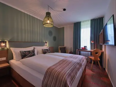 Ein Bett oder Betten in einem Zimmer der Unterkunft Classik Hotel Martinshof, Messe München