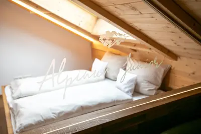 Ein Bett oder Betten in einem Zimmer der Unterkunft Alpinum Junior