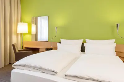 Ein Bett oder Betten in einem Zimmer der Unterkunft NH München Messe