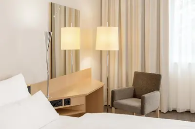 Ein Bett oder Betten in einem Zimmer der Unterkunft NH München Messe