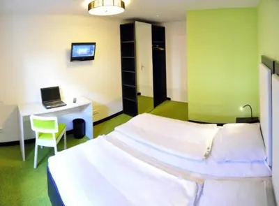 Ein Bett oder Betten in einem Zimmer der Unterkunft Amiga Hotel München Messe