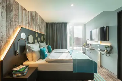 Ein Bett oder Betten in einem Zimmer der Unterkunft Holiday Inn - the niu, Brass Munich Olympiapark by IHG