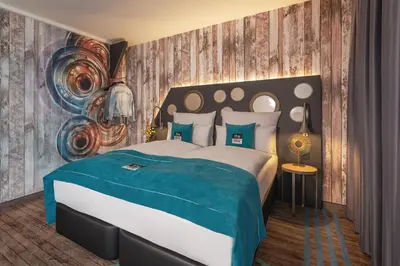Ein Bett oder Betten in einem Zimmer der Unterkunft Holiday Inn - the niu, Brass Munich Olympiapark by IHG