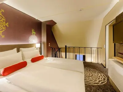 Ein Bett oder Betten in einem Zimmer der Unterkunft Mercure München City Center