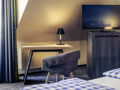 Ein Bett oder Betten in einem Zimmer der Unterkunft Mercure München City Center