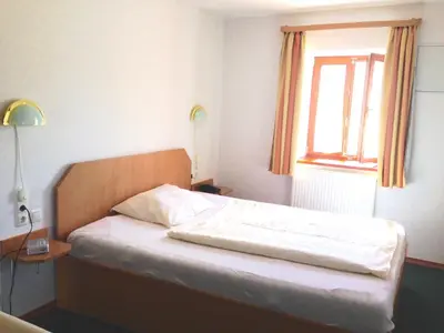 Ein Bett oder Betten in einem Zimmer der Unterkunft Pension Poschmühle