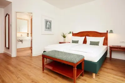 Ein Bett oder Betten in einem Zimmer der Unterkunft Hotel Prinzregent München Messe