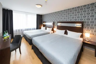 Ein Bett oder Betten in einem Zimmer der Unterkunft Hotel Munich Inn - Design Hotel