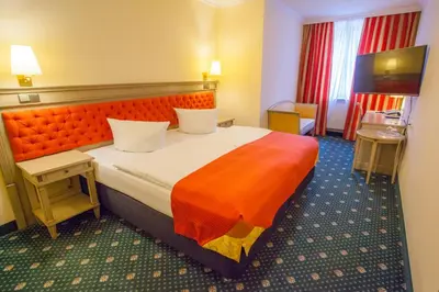 Ein Bett oder Betten in einem Zimmer der Unterkunft Stadthotel Herzog Ludwig