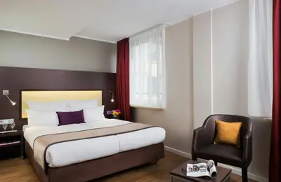 Ein Bett oder Betten in einem Zimmer der Unterkunft Leonardo Hotel München City Center