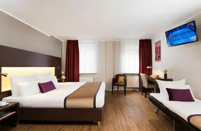 Ein Bett oder Betten in einem Zimmer der Unterkunft Leonardo Hotel München City Center