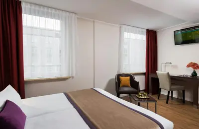 Ein Bett oder Betten in einem Zimmer der Unterkunft Leonardo Hotel München City Center