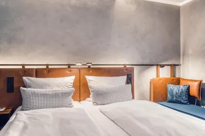 Ein Bett oder Betten in einem Zimmer der Unterkunft Unsöld's Factory Hotel